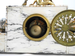 Mantel Clock in Marble with Figurines in brass alloy (messing/laiton) on top of a Lady feeding a Pheasant. Eight-day clock movement with chime. France 1920s.